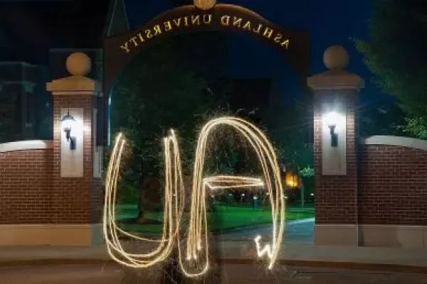 AU spelled out with sparkler in front of arch