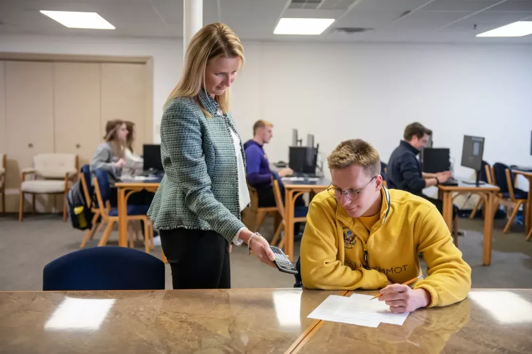 Testing center director helping a student